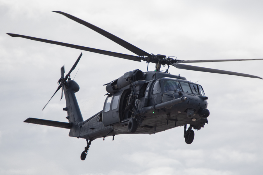 Military helicopter in flight representing retaining ring and wave spring applications in rotorcraft systems