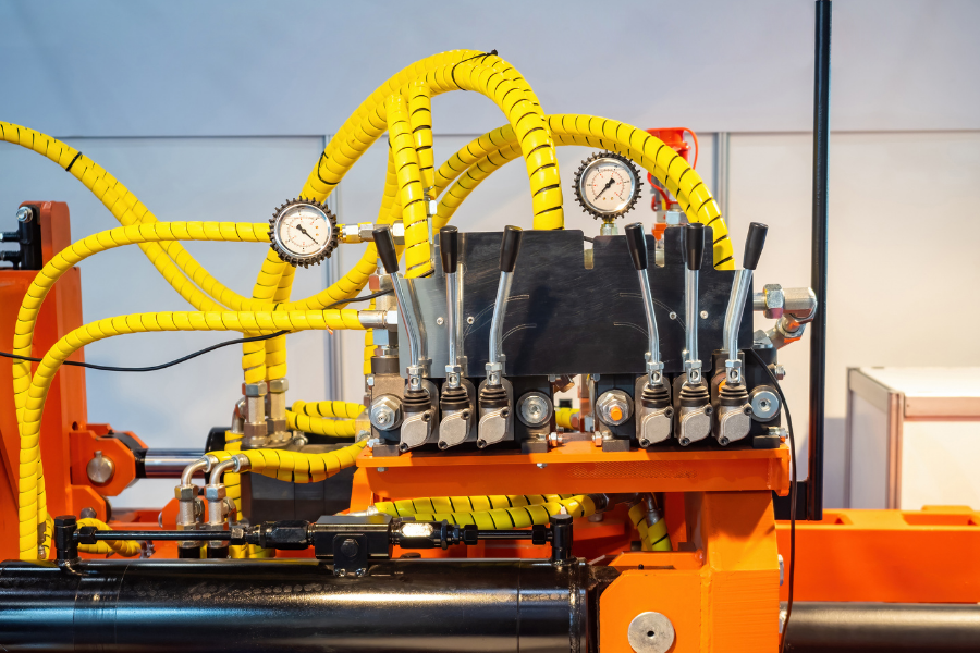 Industrial hydraulic system with hoses, gauges, and control manifold